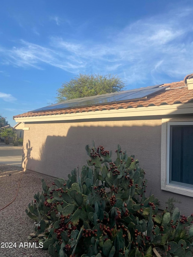 view of property exterior featuring solar panels