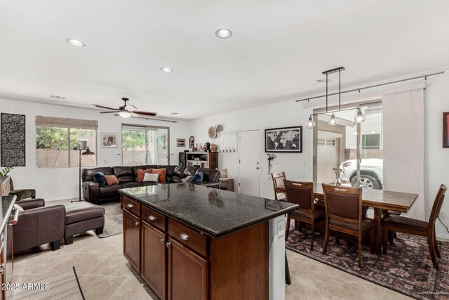 2048 S Martingale Rd, Gilbert, AZ 85295 - kitchen featuring a ceiling fan, light tile patterned floors, pendant lighting, dark stone counters, and recessed lighting