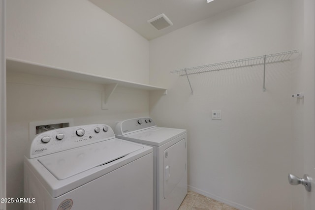 clothes washing area featuring laundry area, visible vents, baseboards, and separate washer and dryer