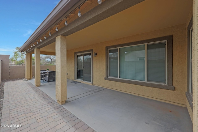 view of patio / terrace featuring fence