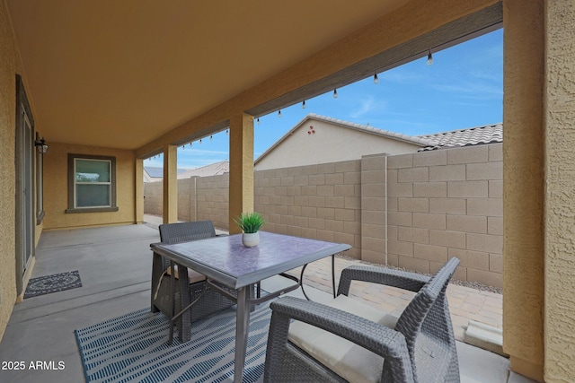 view of patio / terrace featuring fence and outdoor dining area