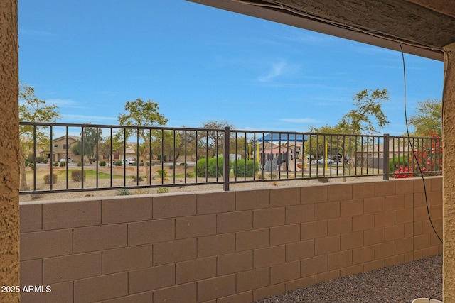 view of patio / terrace featuring fence and a residential view