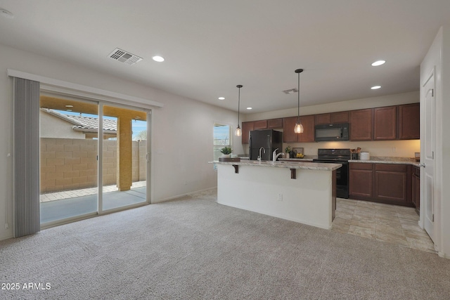 kitchen with visible vents, light colored carpet, black appliances, a kitchen bar, and recessed lighting