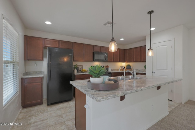 kitchen featuring plenty of natural light, visible vents, a sink, and black appliances