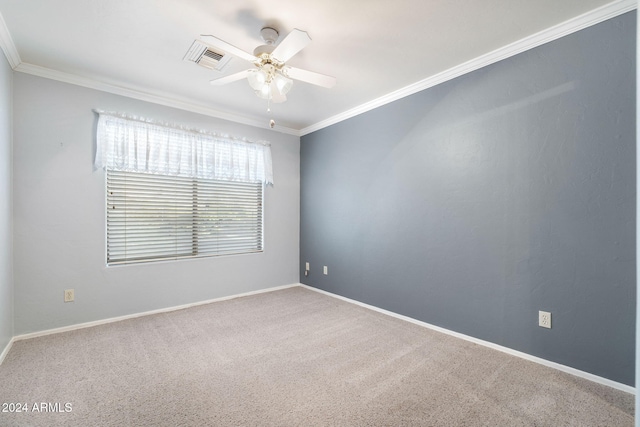 carpeted spare room featuring ceiling fan and ornamental molding