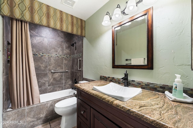 full bathroom with tile patterned flooring, shower / tub combo, vanity, and toilet