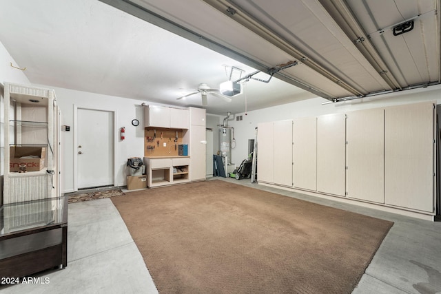 garage featuring a garage door opener and water heater