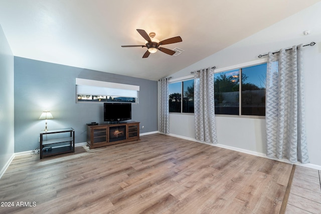 living room featuring wood-type flooring, ceiling fan, and lofted ceiling