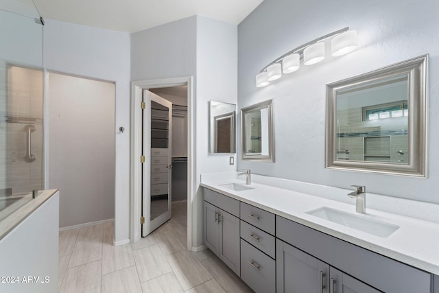 bathroom with vanity, tile patterned floors, and a shower with shower door