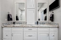 full bath featuring double vanity and a sink