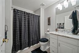 full bath featuring visible vents, toilet, vanity, and mail area