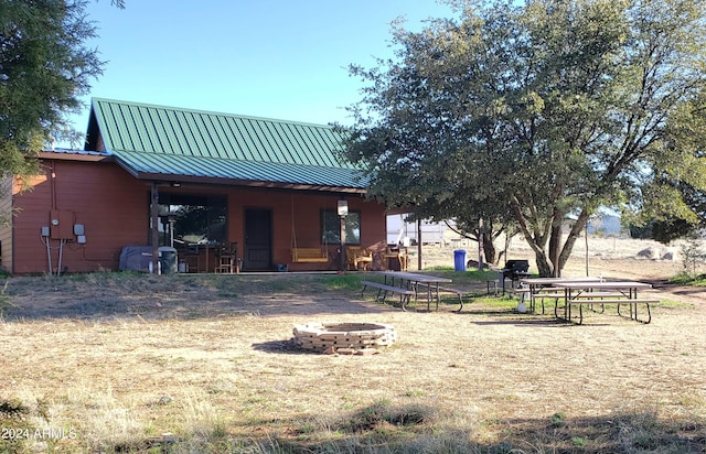 rear view of house featuring a fire pit