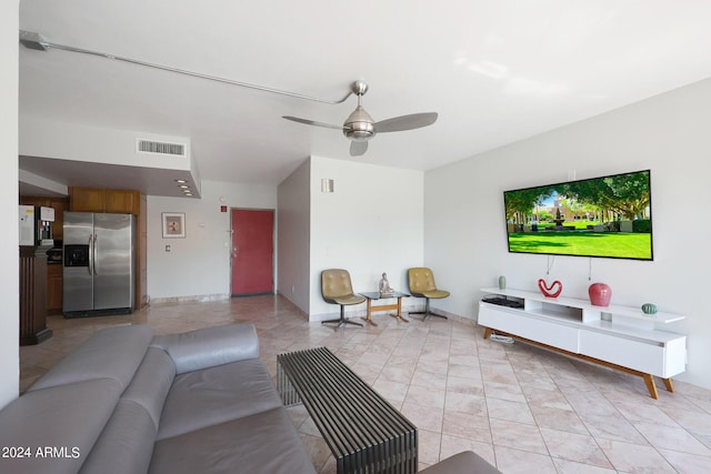 living room featuring a ceiling fan and visible vents