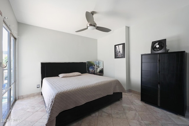 bedroom with light tile patterned flooring, ceiling fan, and baseboards