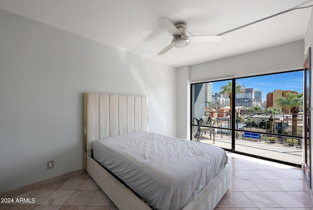 bedroom with light tile patterned flooring, access to outside, a view of city, and ceiling fan