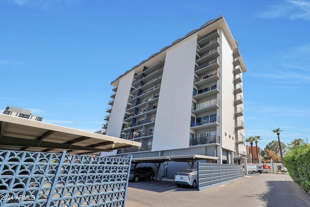 view of building exterior featuring covered parking