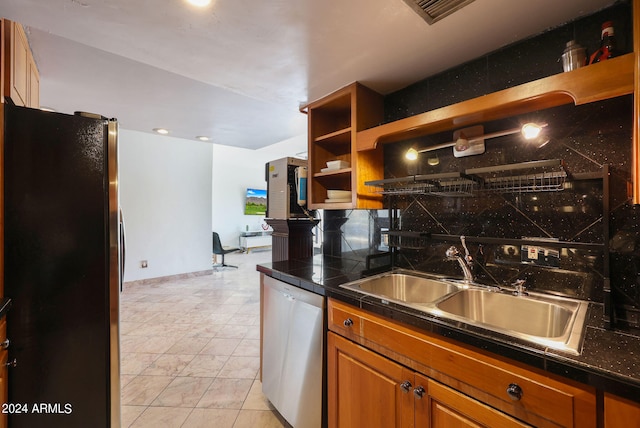 kitchen with backsplash, sink, and stainless steel appliances