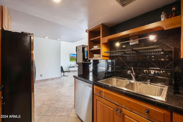 kitchen with open shelves, a sink, brown cabinetry, stainless steel appliances, and decorative backsplash