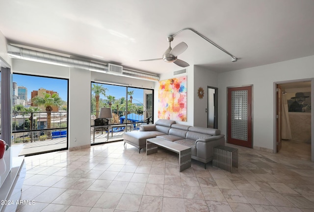 living area featuring visible vents, light tile patterned flooring, and ceiling fan