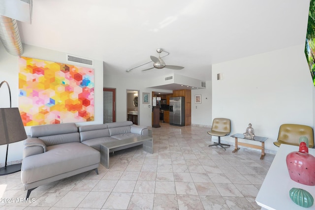 living area featuring visible vents and a ceiling fan