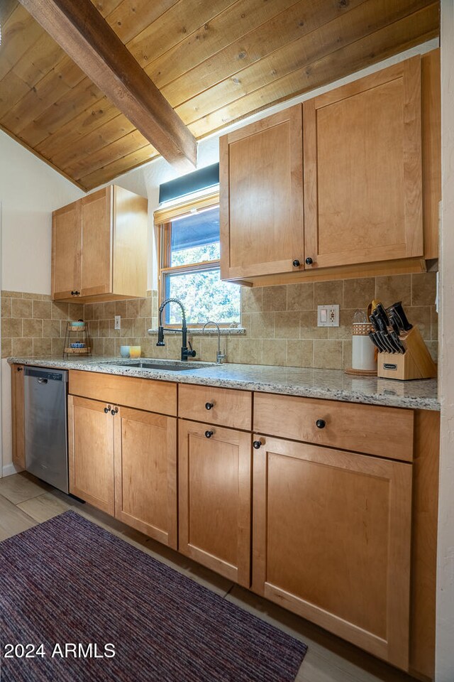 kitchen with dishwasher, sink, light stone countertops, tasteful backsplash, and light hardwood / wood-style floors