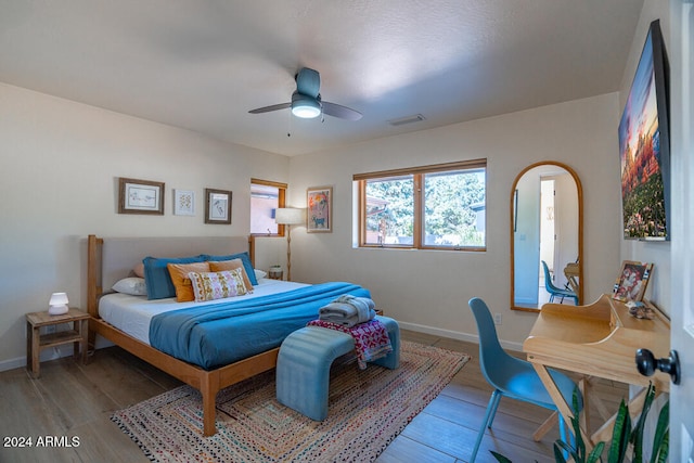 bedroom with hardwood / wood-style floors and ceiling fan