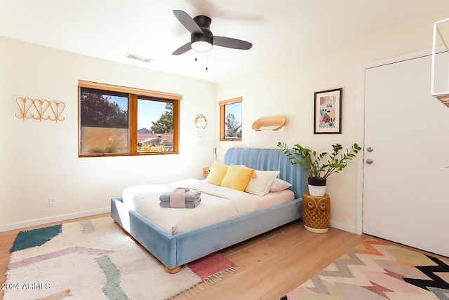 bedroom with ceiling fan and light hardwood / wood-style floors