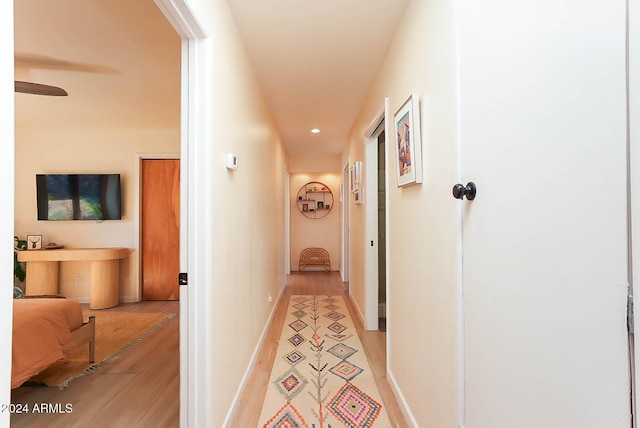 hallway with light hardwood / wood-style floors