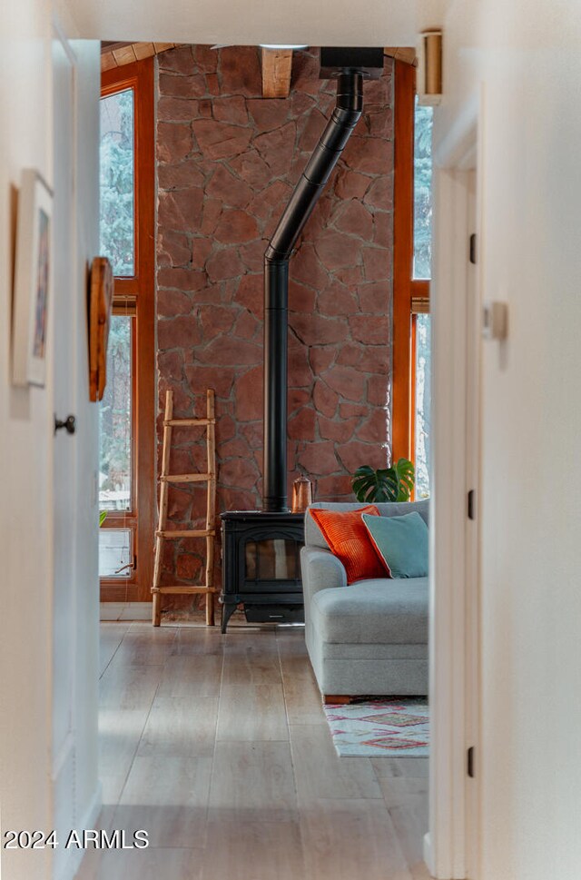 unfurnished living room featuring hardwood / wood-style floors and a wood stove