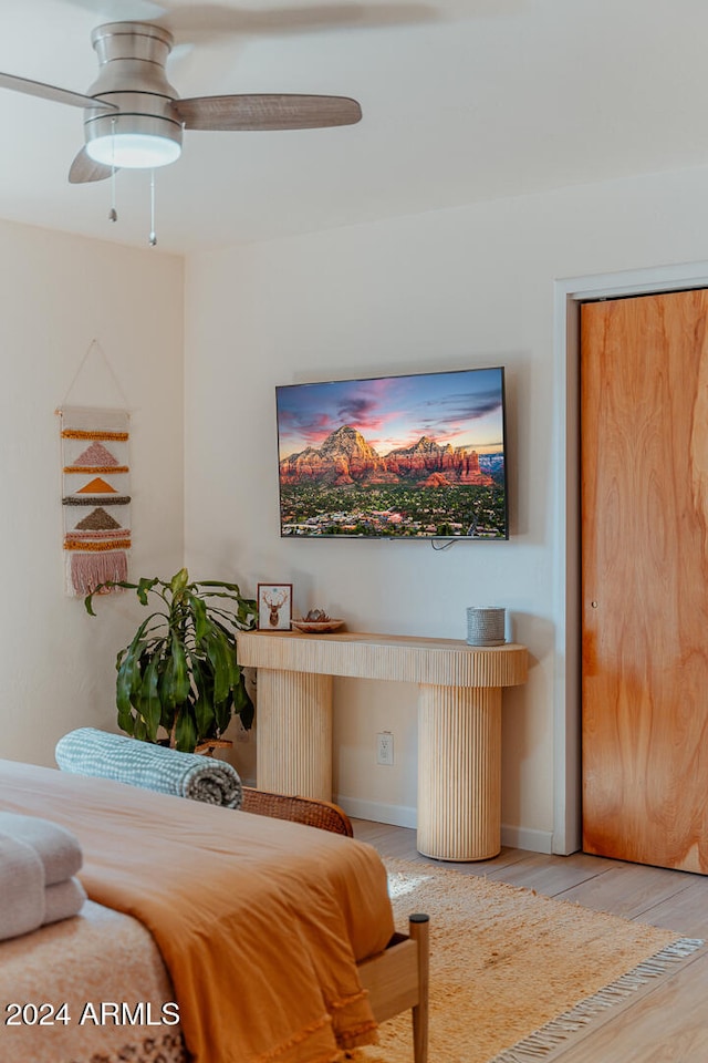 living room featuring ceiling fan and light wood-type flooring