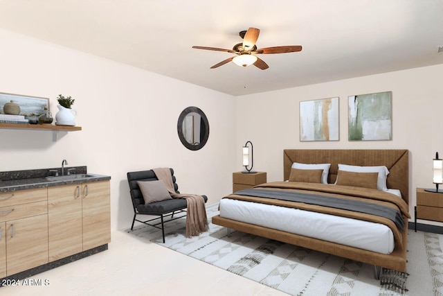 bedroom featuring ceiling fan and sink