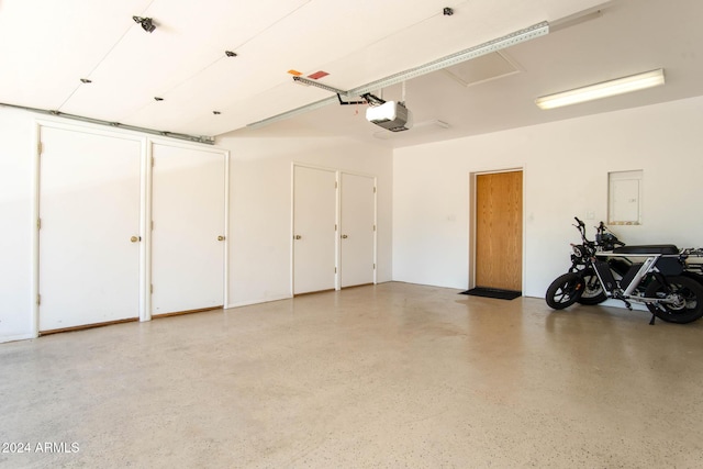 garage with electric panel and a garage door opener