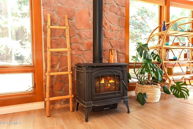 details with wood-type flooring and a wood stove