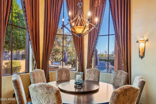 dining room featuring a wealth of natural light and a notable chandelier