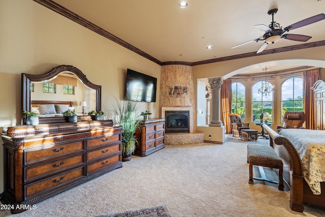 carpeted bedroom with ornate columns, crown molding, and ceiling fan