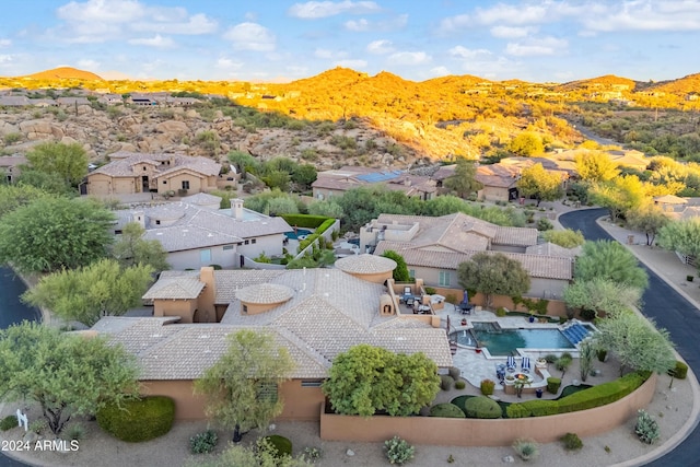 birds eye view of property with a mountain view