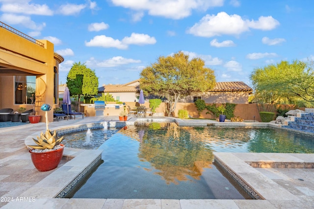 view of swimming pool with pool water feature, a patio area, and a jacuzzi