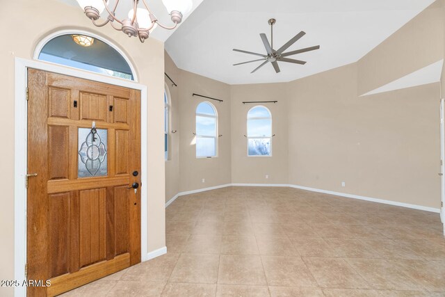 tiled entrance foyer with ceiling fan with notable chandelier