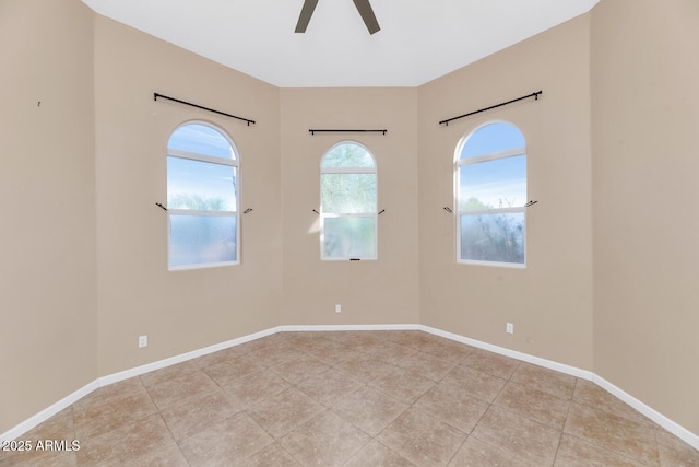 spare room featuring light tile patterned flooring and ceiling fan