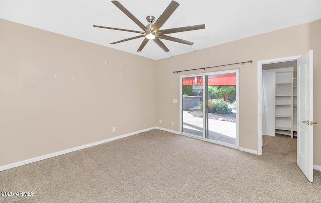 unfurnished room featuring ceiling fan and carpet flooring