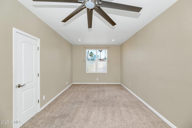 carpeted spare room with ceiling fan