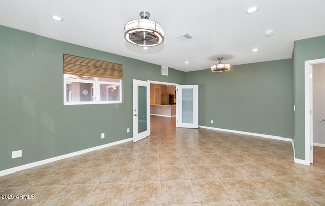 empty room with french doors and light tile patterned floors