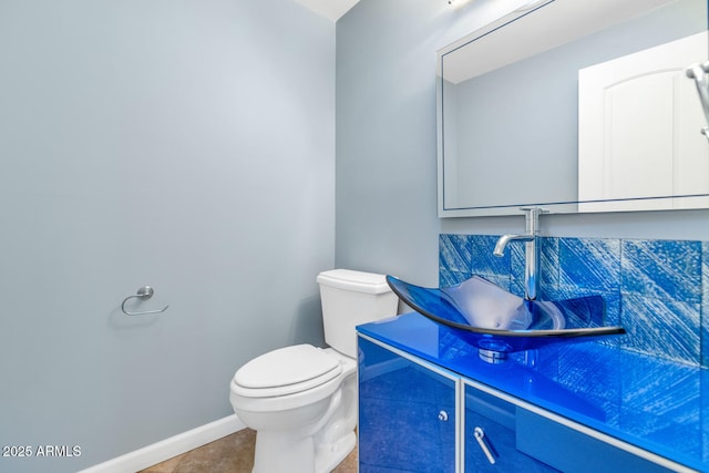 bathroom with tile patterned floors, vanity, and toilet