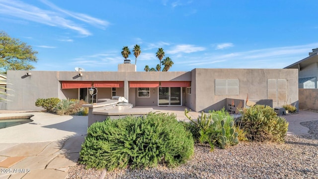 adobe home with area for grilling and a patio area