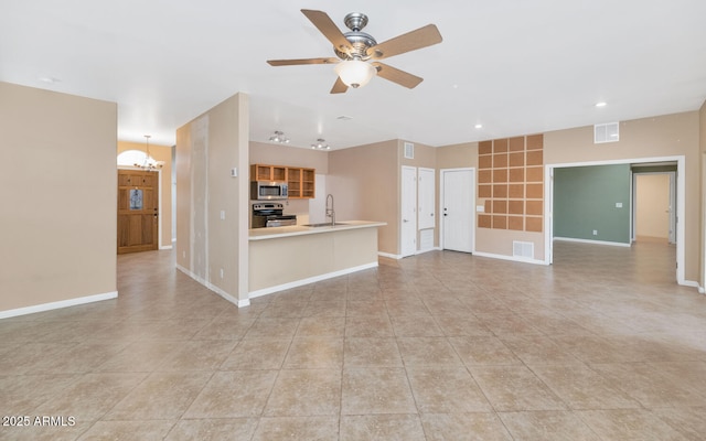 unfurnished living room with light tile patterned flooring, sink, and ceiling fan with notable chandelier