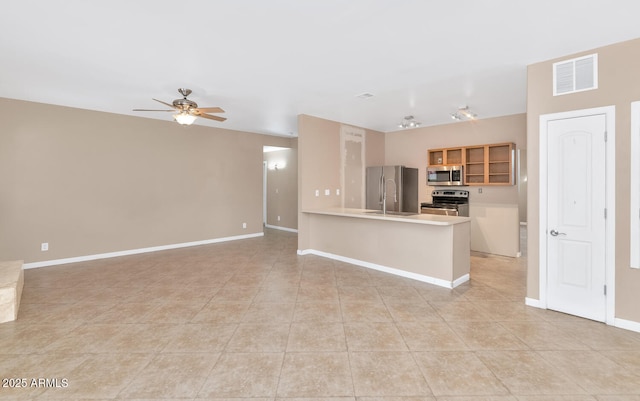 kitchen featuring sink, light tile patterned floors, ceiling fan, kitchen peninsula, and stainless steel appliances