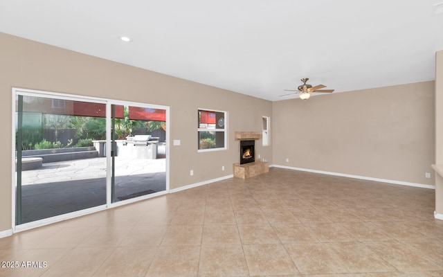 unfurnished living room with light tile patterned flooring and ceiling fan