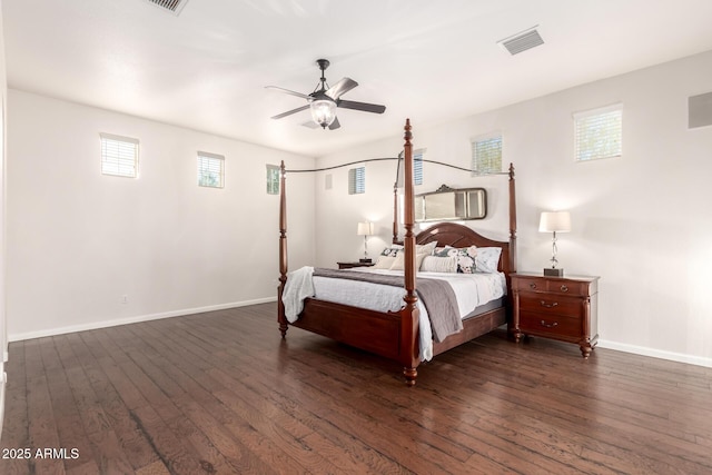 bedroom with ceiling fan, dark wood-style flooring, visible vents, and baseboards