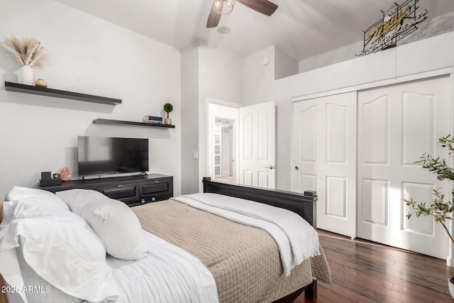 bedroom featuring ceiling fan, a closet, and dark wood-style flooring