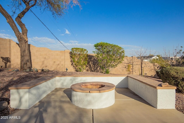 view of patio featuring a fenced backyard and a fire pit